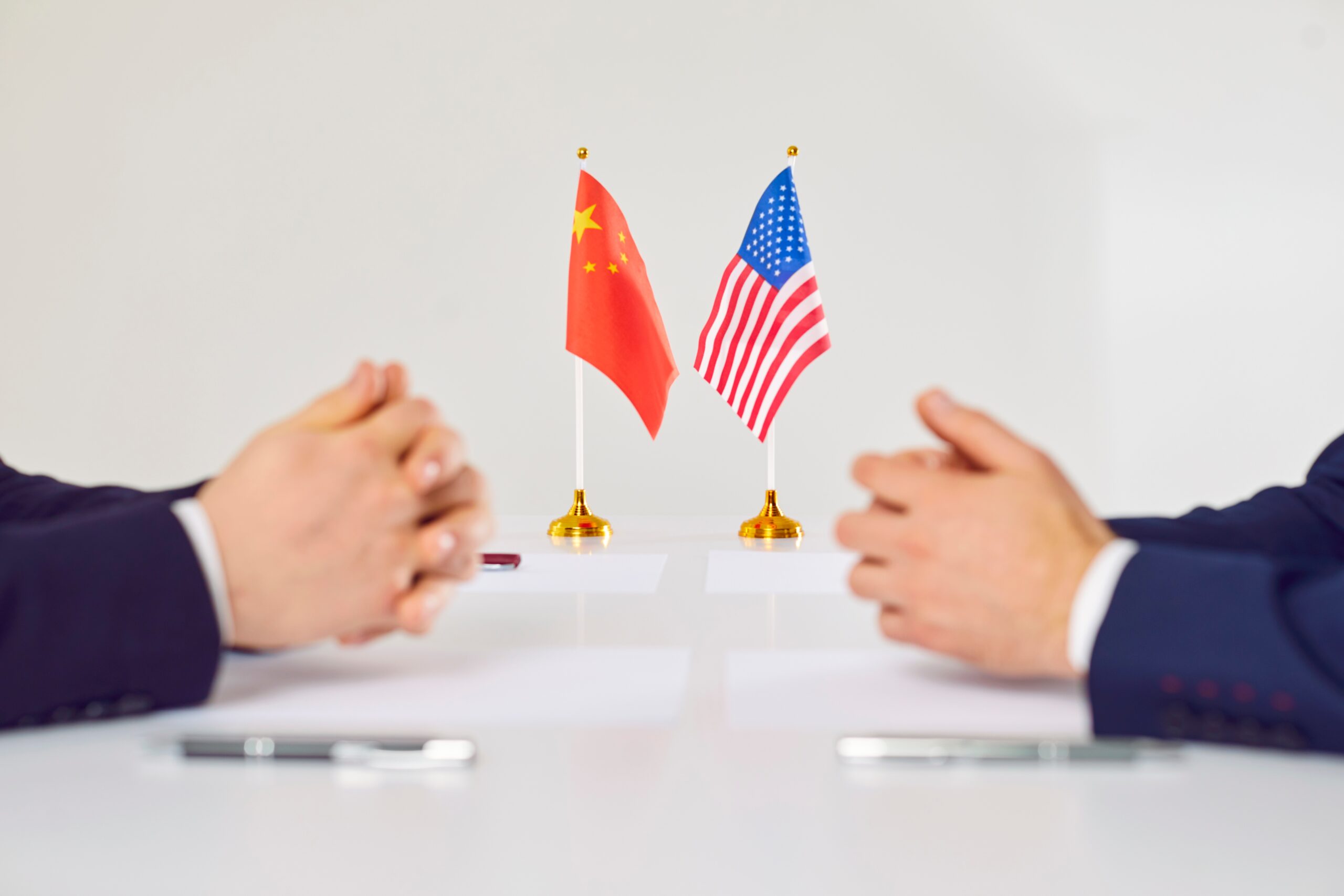 United States and China flags at the negotiation table