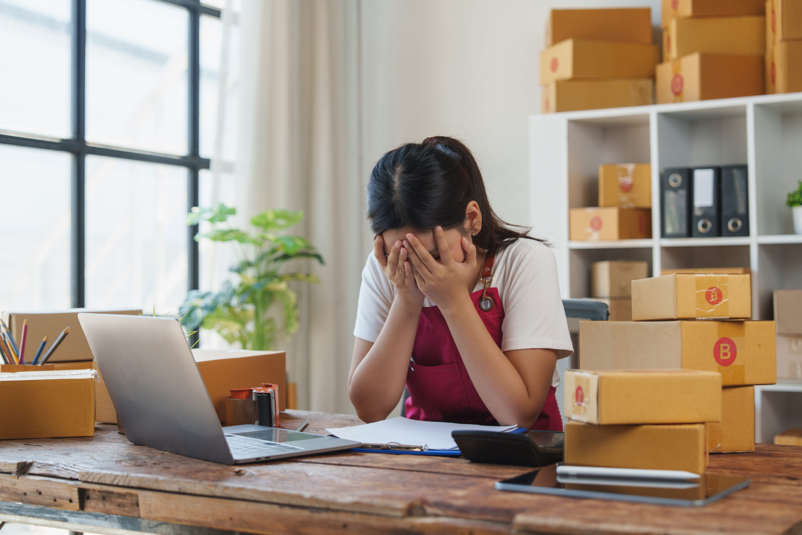 Stressed young woman facing problems running online business